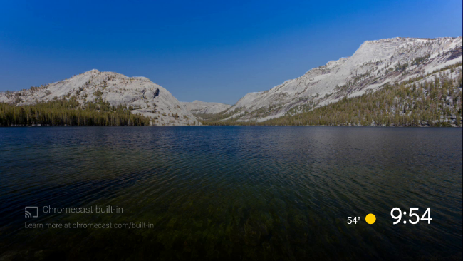 The default Android TV screen saver of a lake surrounded by mountains.