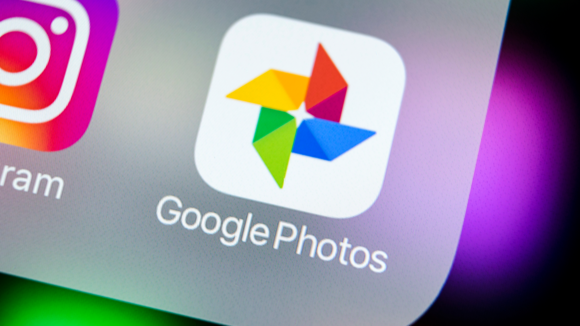 Google Photos smartphone application icon on iPhone X screen close up