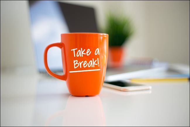 An orange coffee mug with &quot;Take a Break!&quot; printed on it.