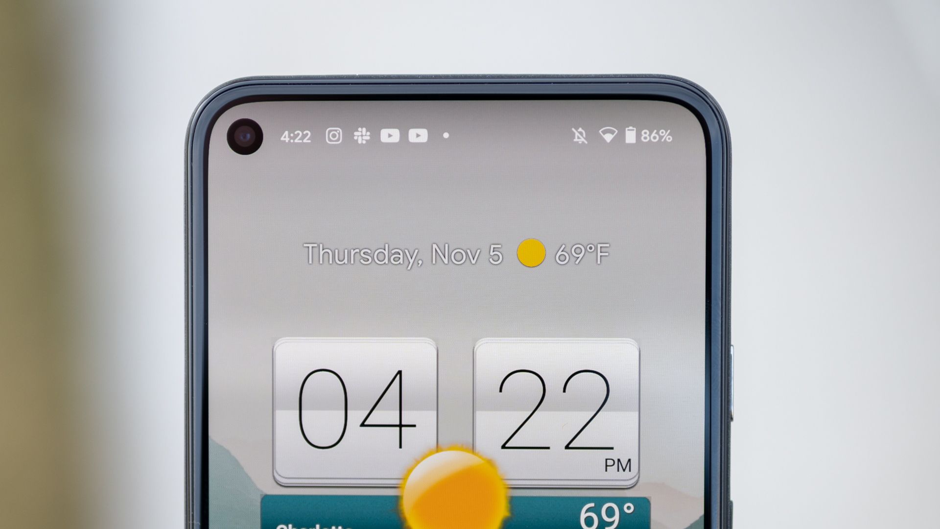 A close up of the top half of the Pixel 5's display, showing the hole punch camera cutout