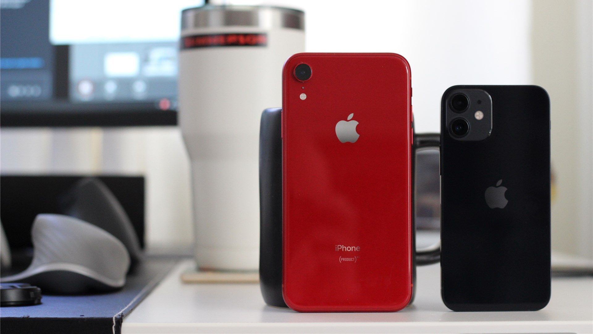 The red iPhone XR next to the black iPhone 12 Mini for size comparison.