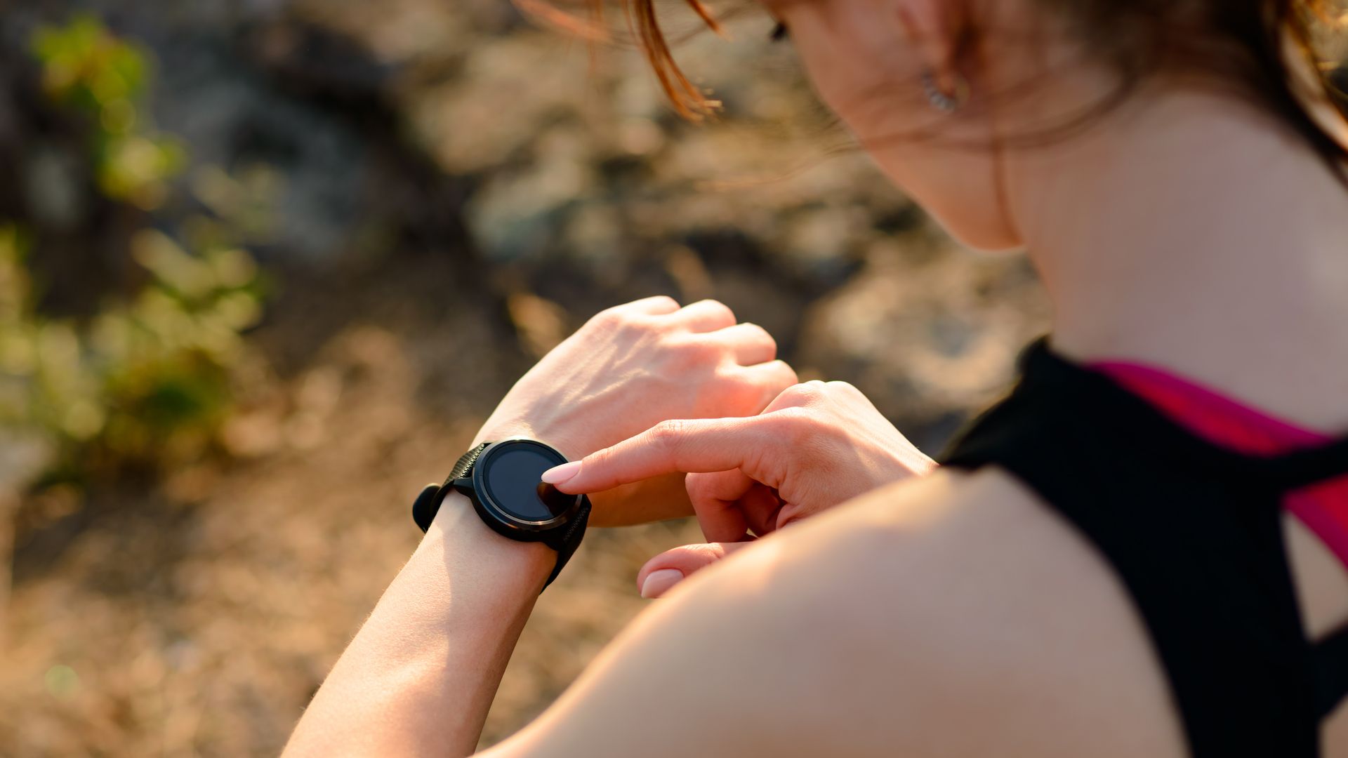 Woman using a watch while exercising.