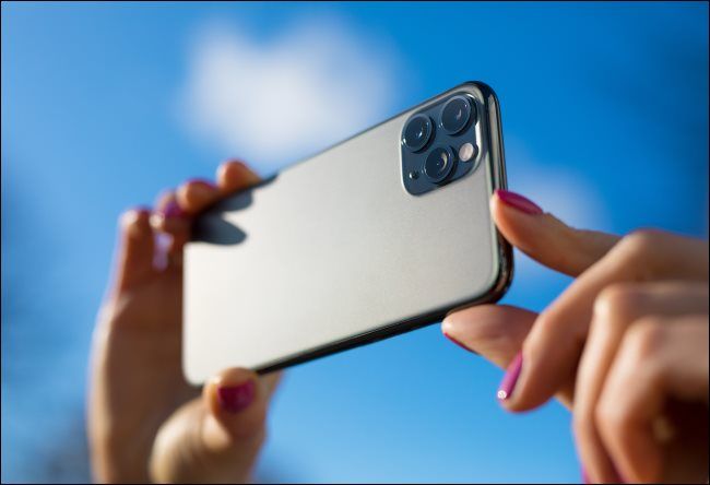 A person taking a photo with an iPhone