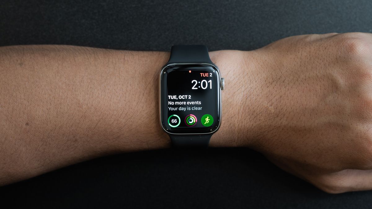 Person wearing an Apple Watch with complication on-screen
