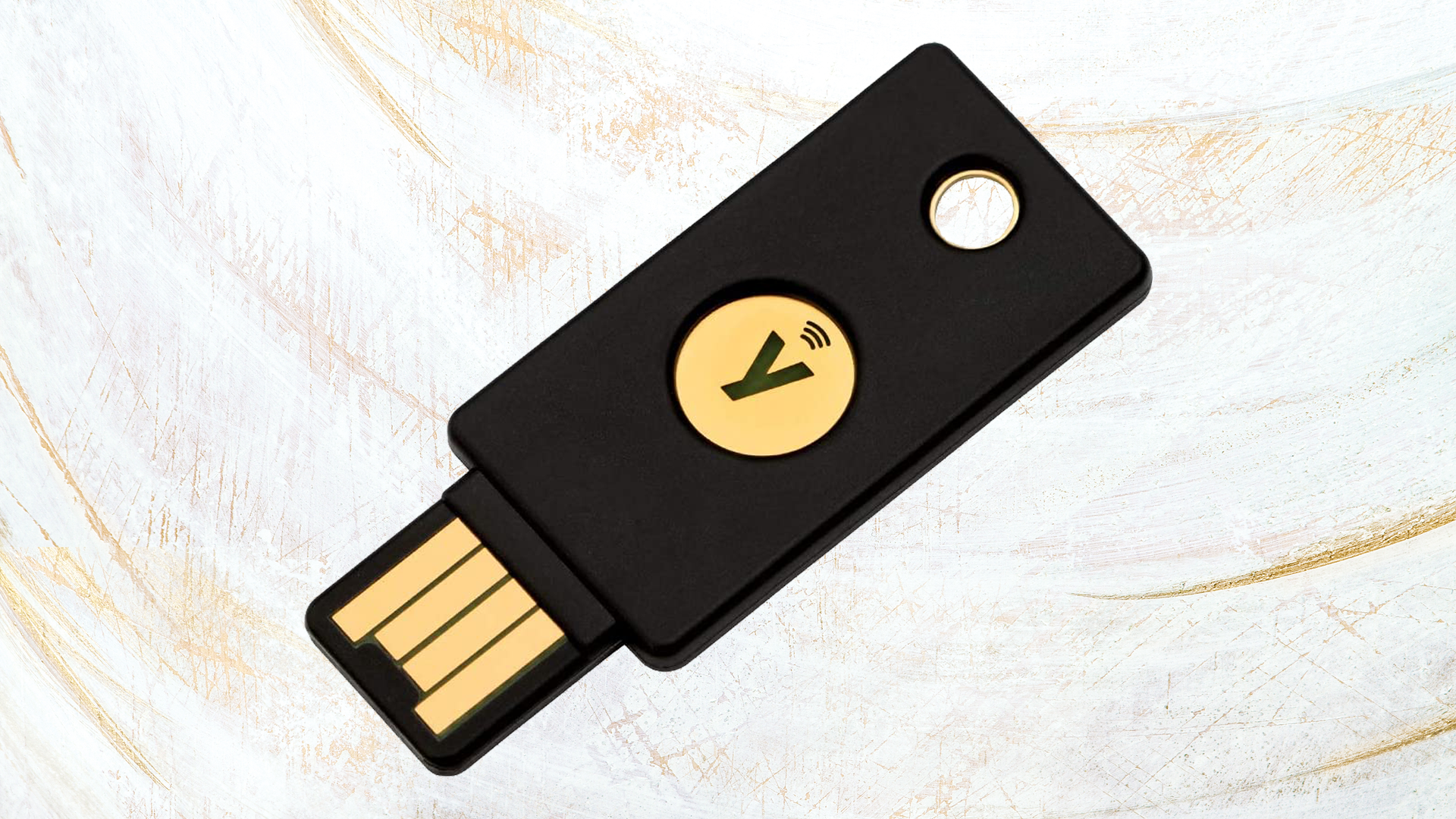YubiKey security key on a white and gold antique painted and carved textured background