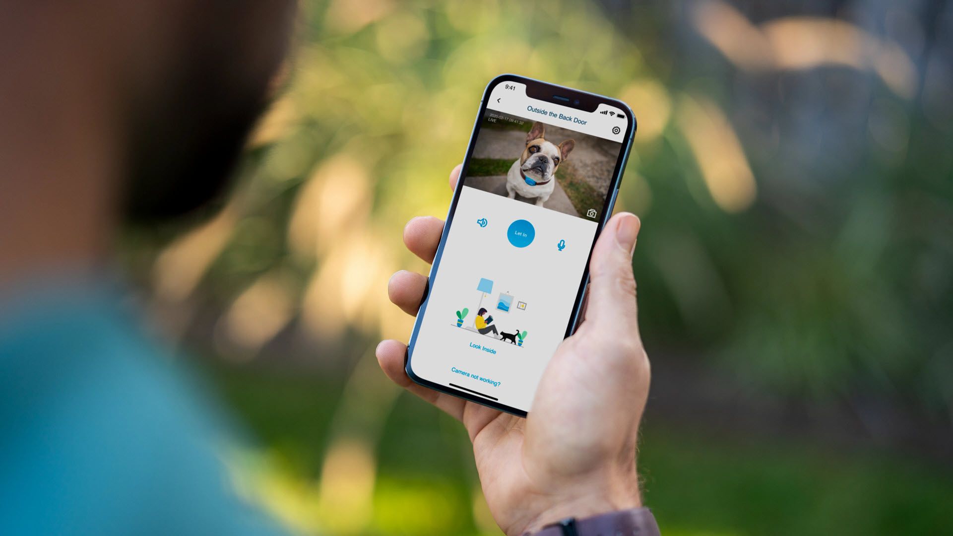 A man looking at a dog through a camera app.