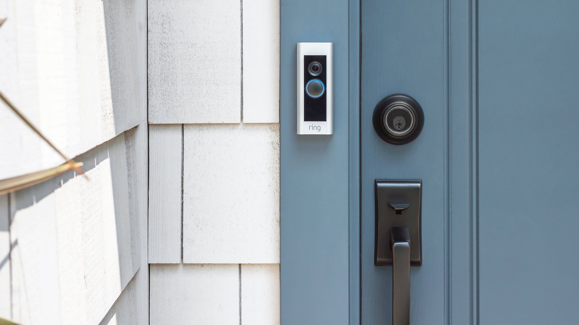 A Ring video doorbell mounted on a door frame.