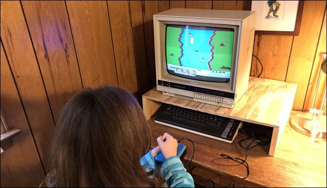 A child playing River Raid on an Atari 800XL computer.