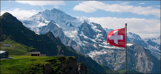 Swiss flag flown in front of a mountain