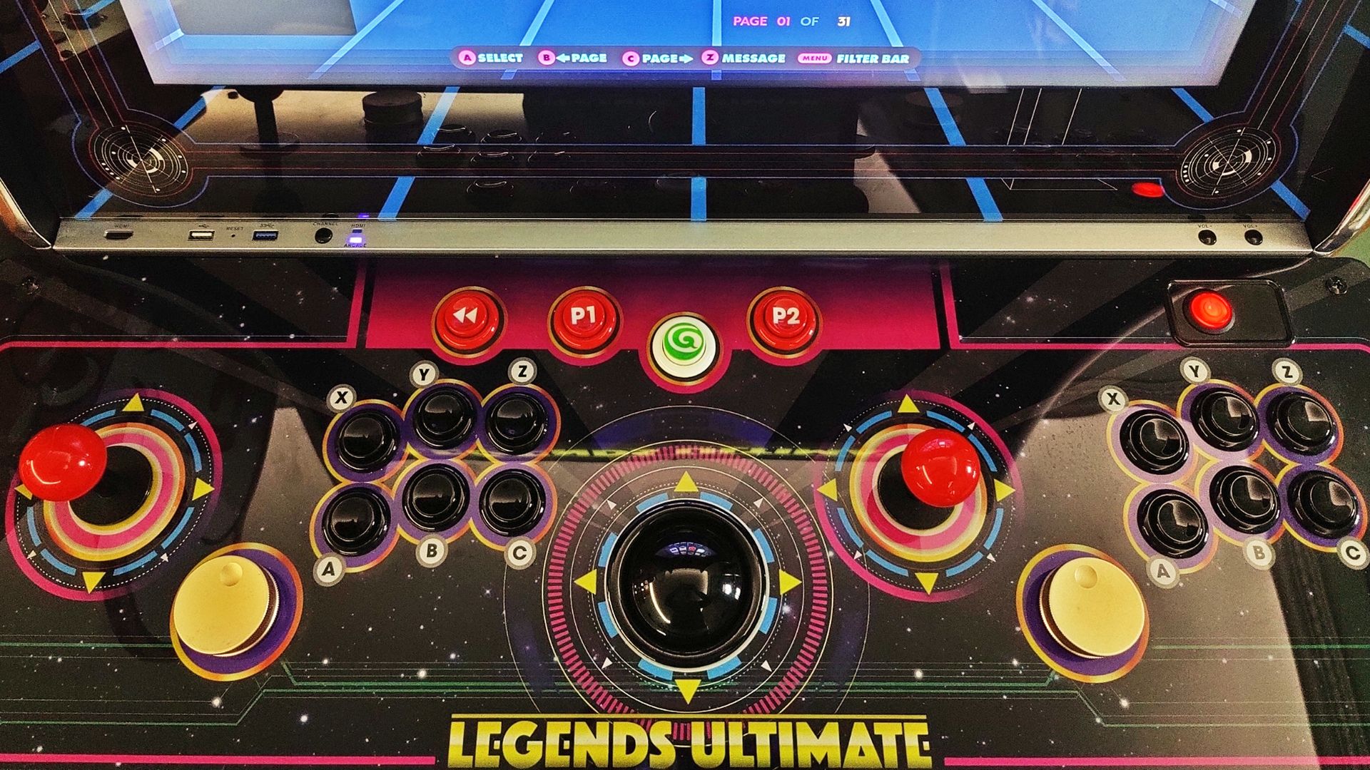 A top down view of the Legends Ultimate control deck, with two joysticks, 12 buttons, two spinners, and a trackball.