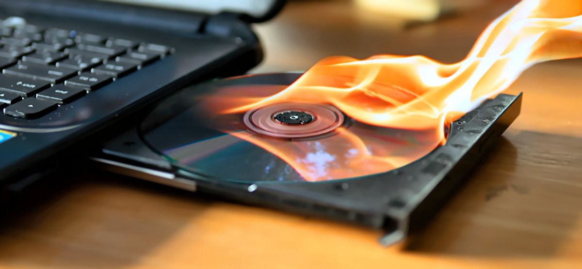 Burning a CD in a laptop drive.