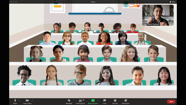 Children on a Zoom call, appearing to be in the same classroom while a teacher waves