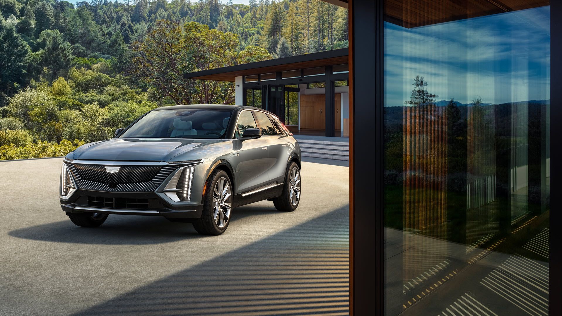 Gray Cadillac Lyriq parked outside of a home.