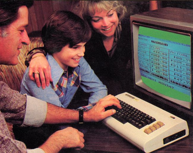 A mom, dad, and son gathered around a Commodore VIC-20.