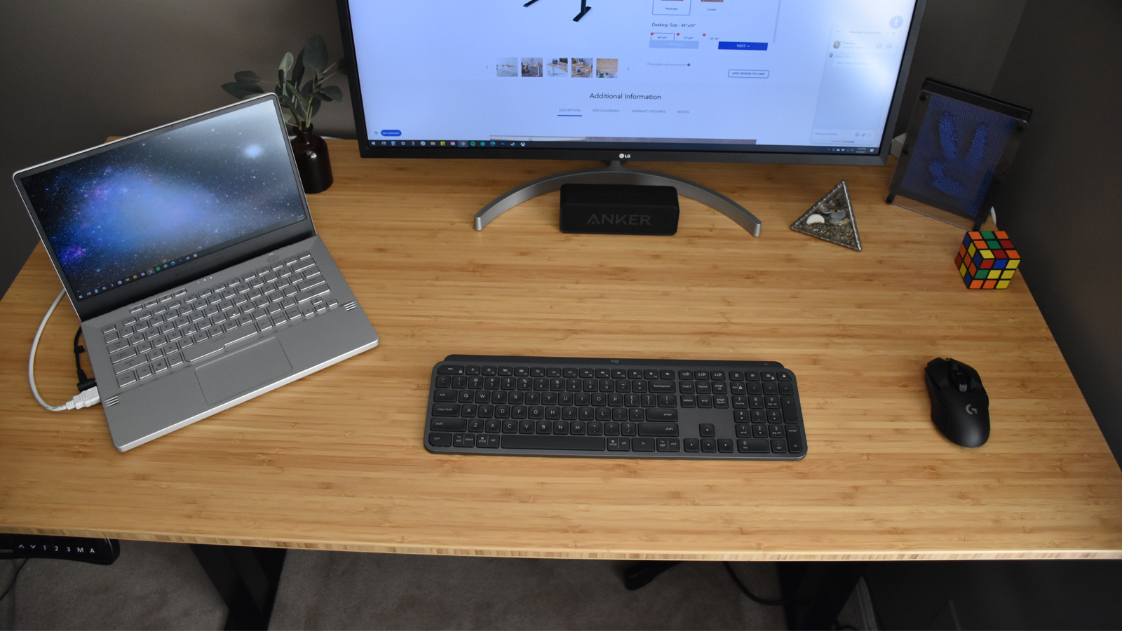 View of desk with laptop, monitor, keyboard, mouse, and other trinkets on it
