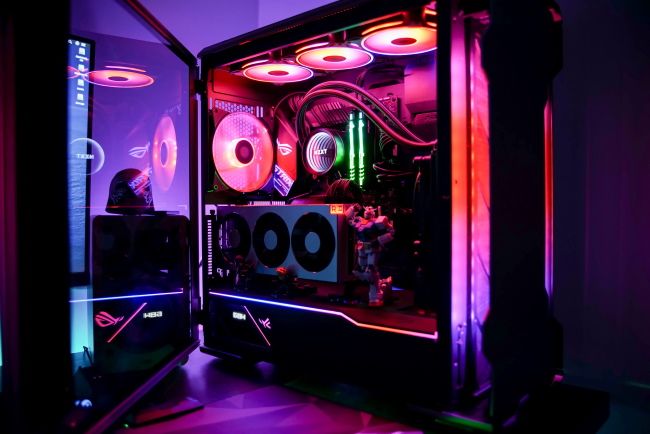 Gaming PC with the side panel opened, showing internal RGB lighting.