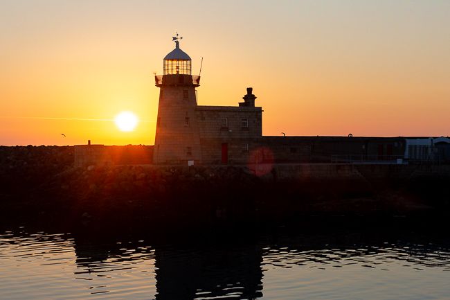 sunrise over a lighthouse