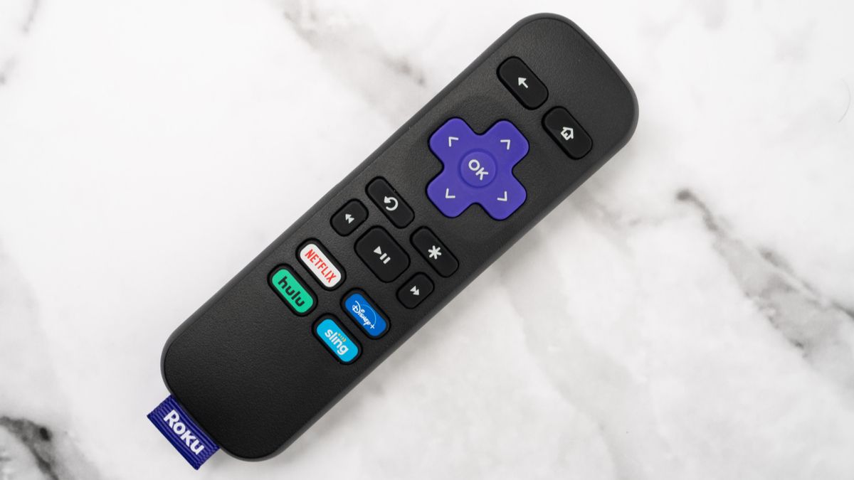 A Roku remote laying on a table