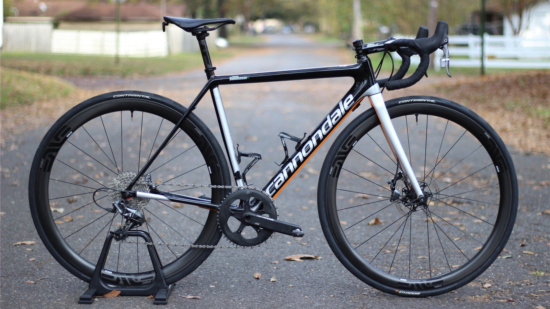 A Cannondale Supersix Evo in black, silver, and orange