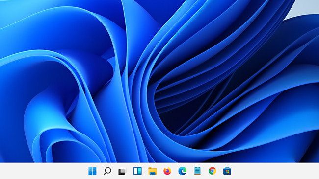 The Windows 11 taskbar arrives with centered icons and Start button.