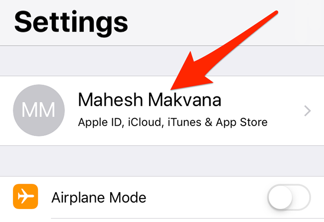 Tap the account name in the Settings app on an iPhone.