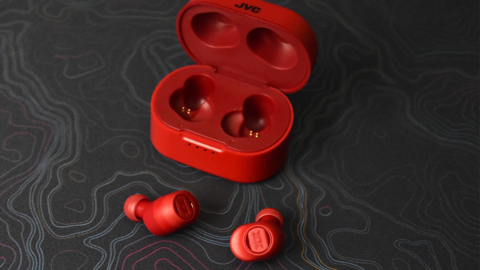 View of earbuds on table in front of open case
