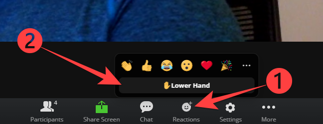 Choose "Reactions" button and then pick "Lower Hand" to lower hand in Zoom for web.