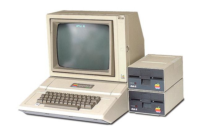 An Apple II with two Disk II floppy drives beside it.