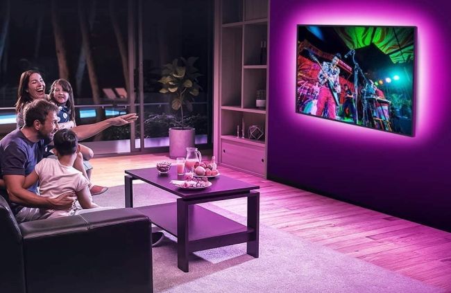 family in living room with TV backlit by led strip