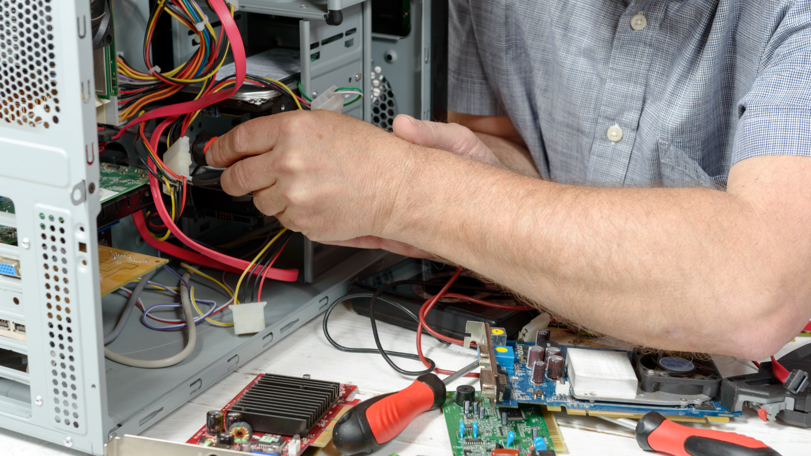 Close up on the hands of computer technician working on a tower.