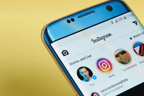 Instagram app open on a smartphone displaying stories and live feeds.