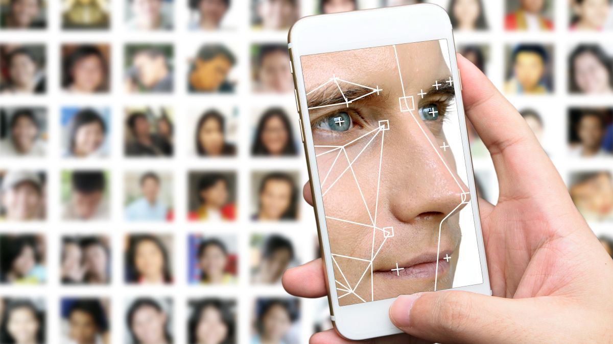 Man's face in a facial recognition app on a smartphone