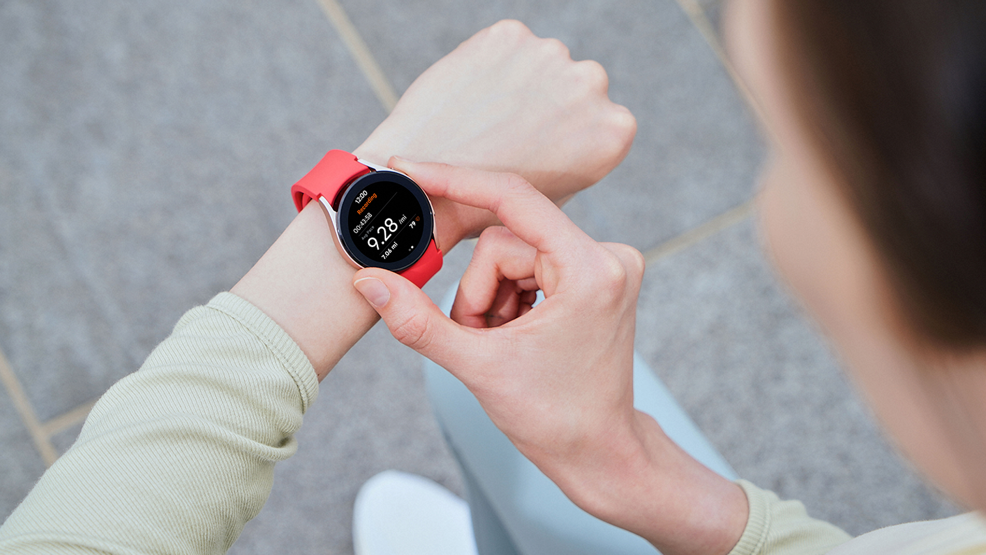 The Samsung Galaxy Watch 4 with a red wriststrap.