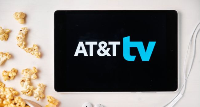 AT&T TV logo on a tablet next to spilled popcorn