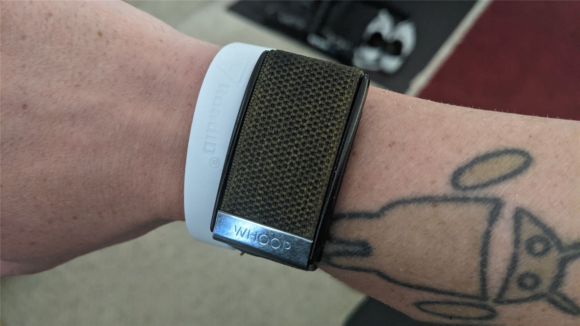 The Whoop band on my wrist; Android tattoo above, Road ID bracelet below