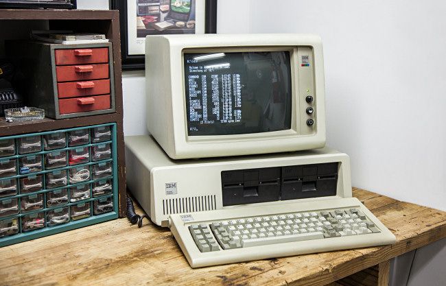 An IBM PC 5150 on a workbench.