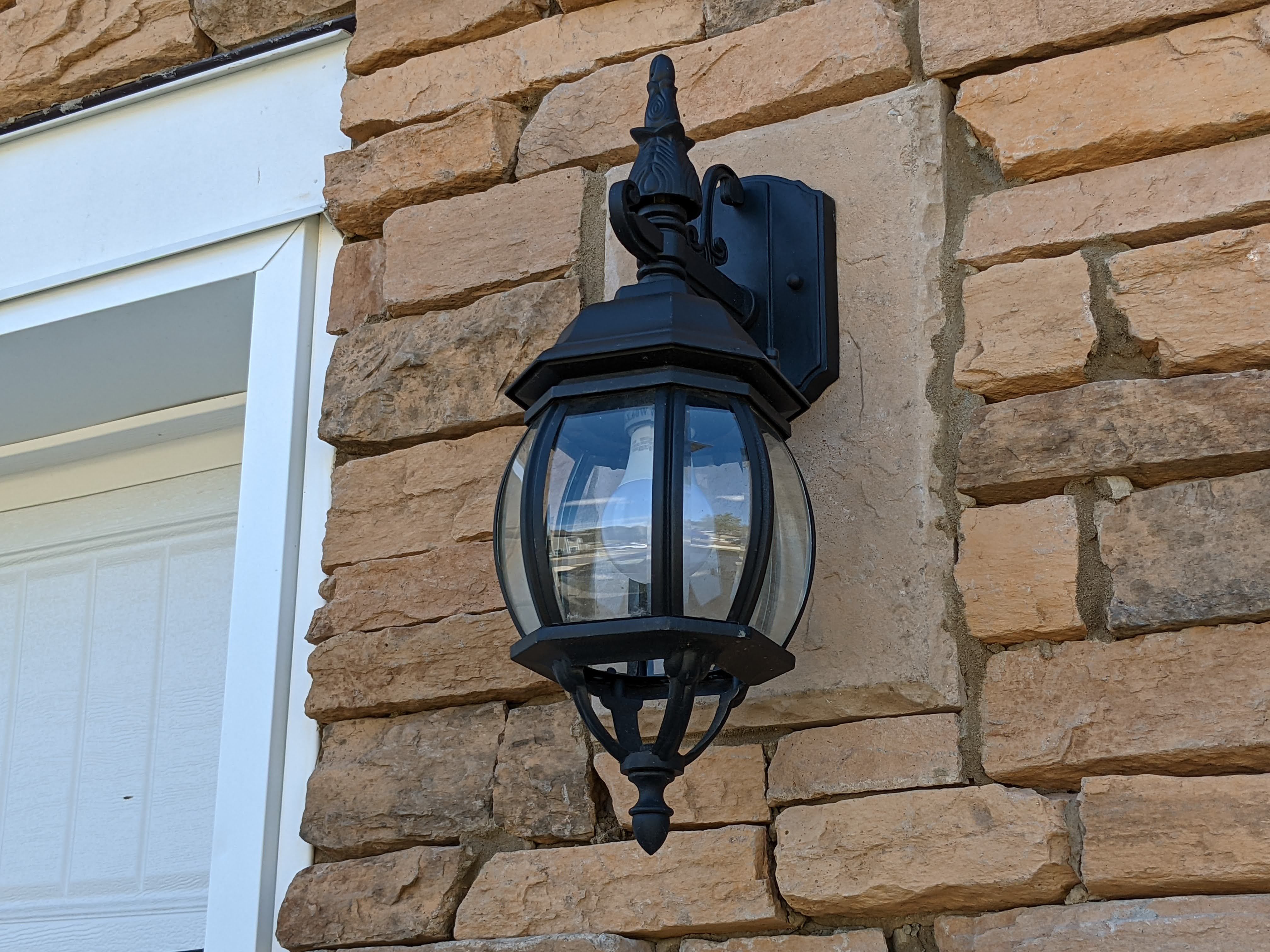 A porch light on the side of a house