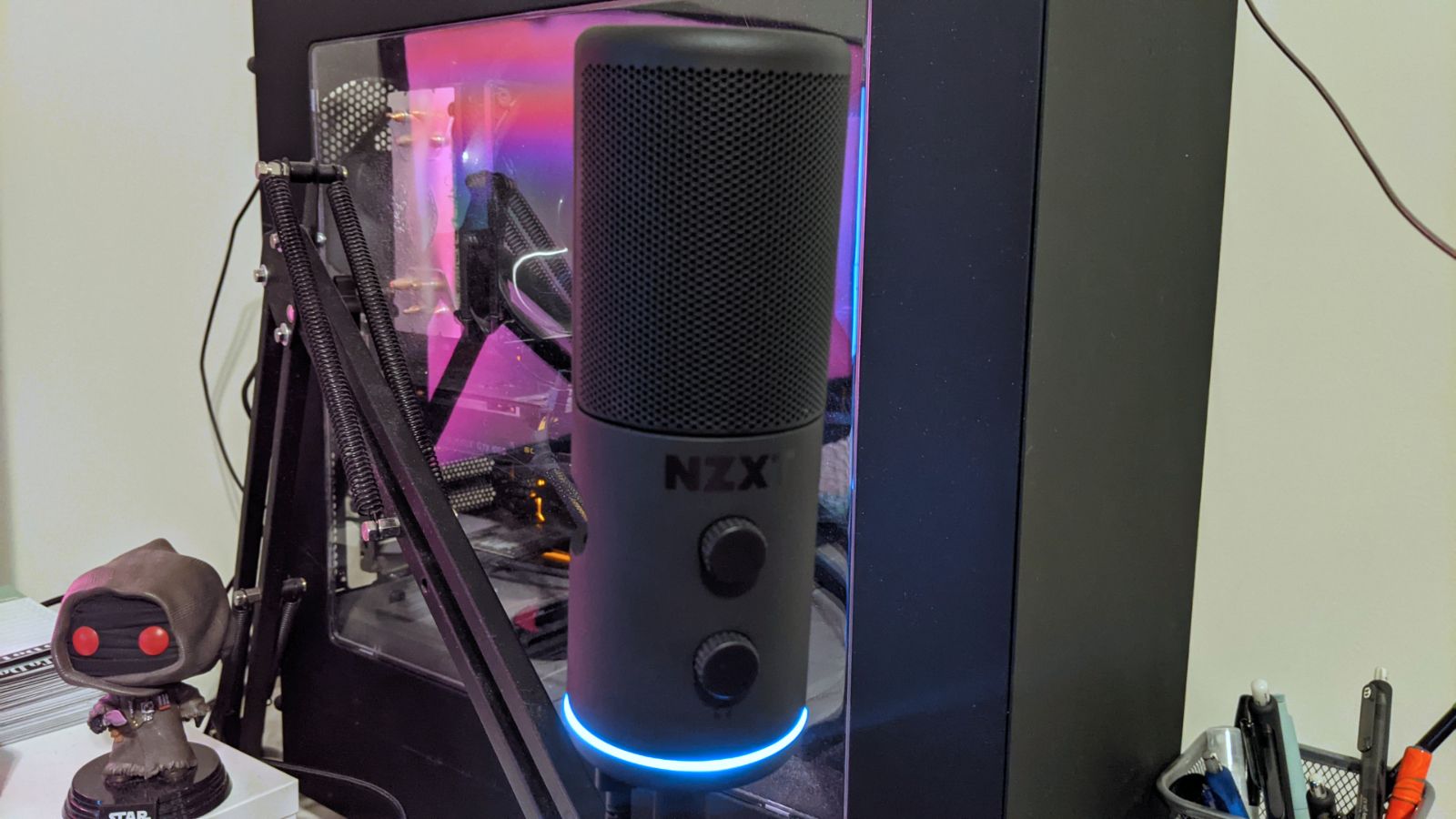 NZXT Capsule microphone on a boom arm in front of computer