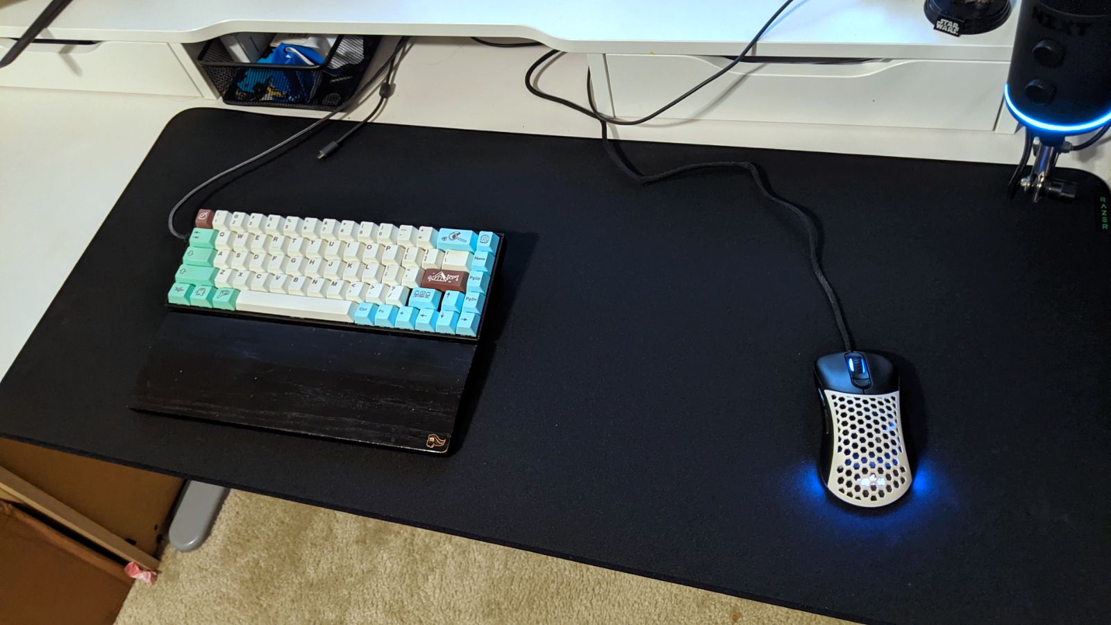 The XXL black Razor Strider mousepad on a desk with a keyboard and mouse.