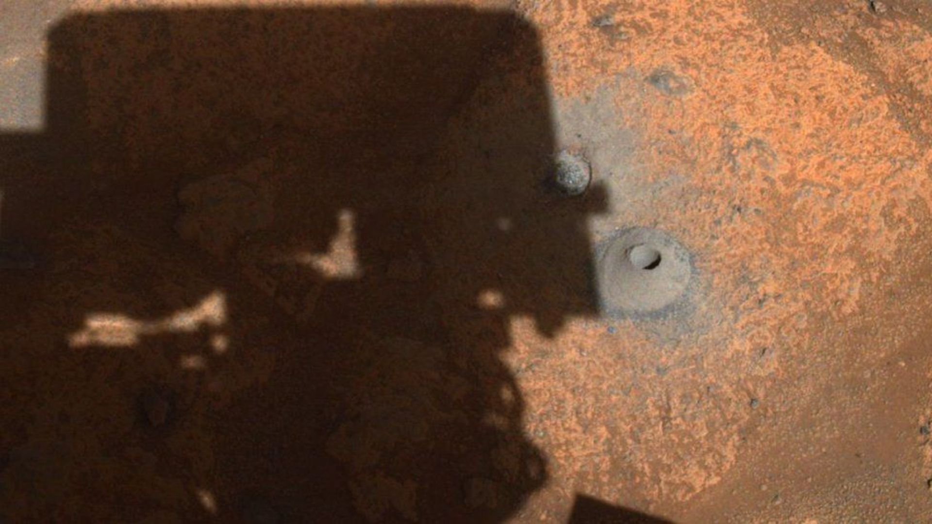 Rover drilling a hole in Mars