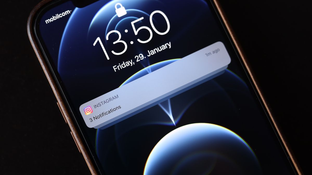 An iPhone 12 Pro displaying an Instagram notification.