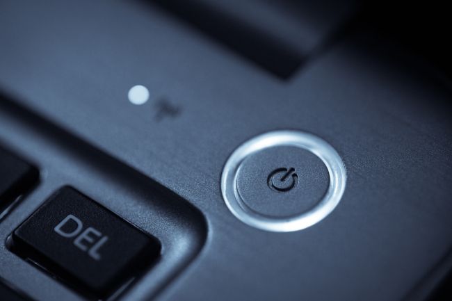 Round power button above a laptop keyboard.