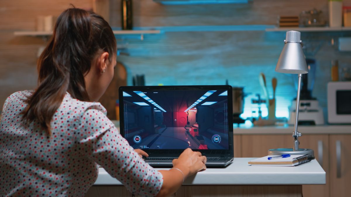 Young woman gaming on a laptop