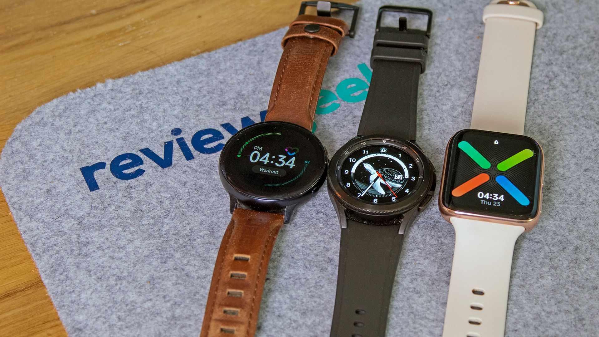 A Galaxy Watch Active 2 next to a Galaxy Watch 4, next to an Oppo Wear OS watch