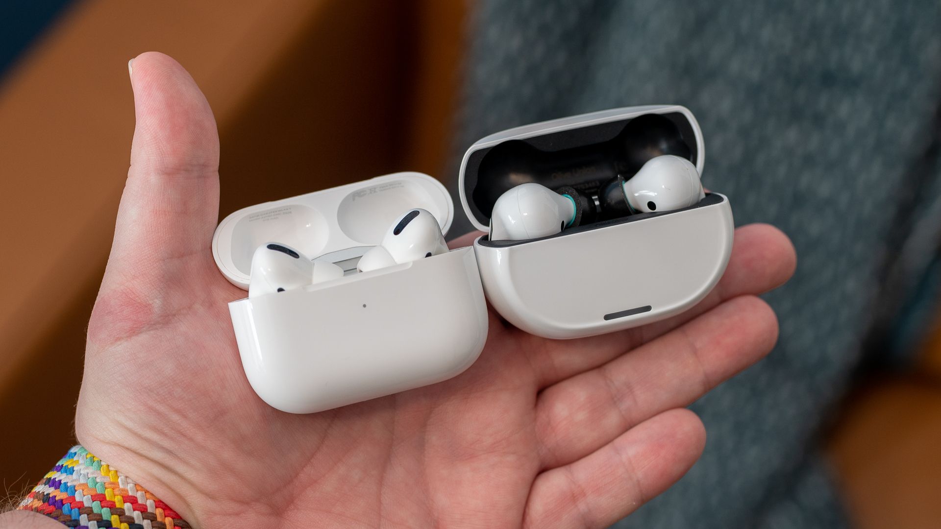Two sets of wireless earbuds cases that are similar sized.