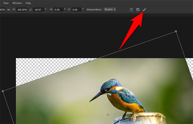 Freely rotate a photo and then click the checkmark icon in Photoshop.