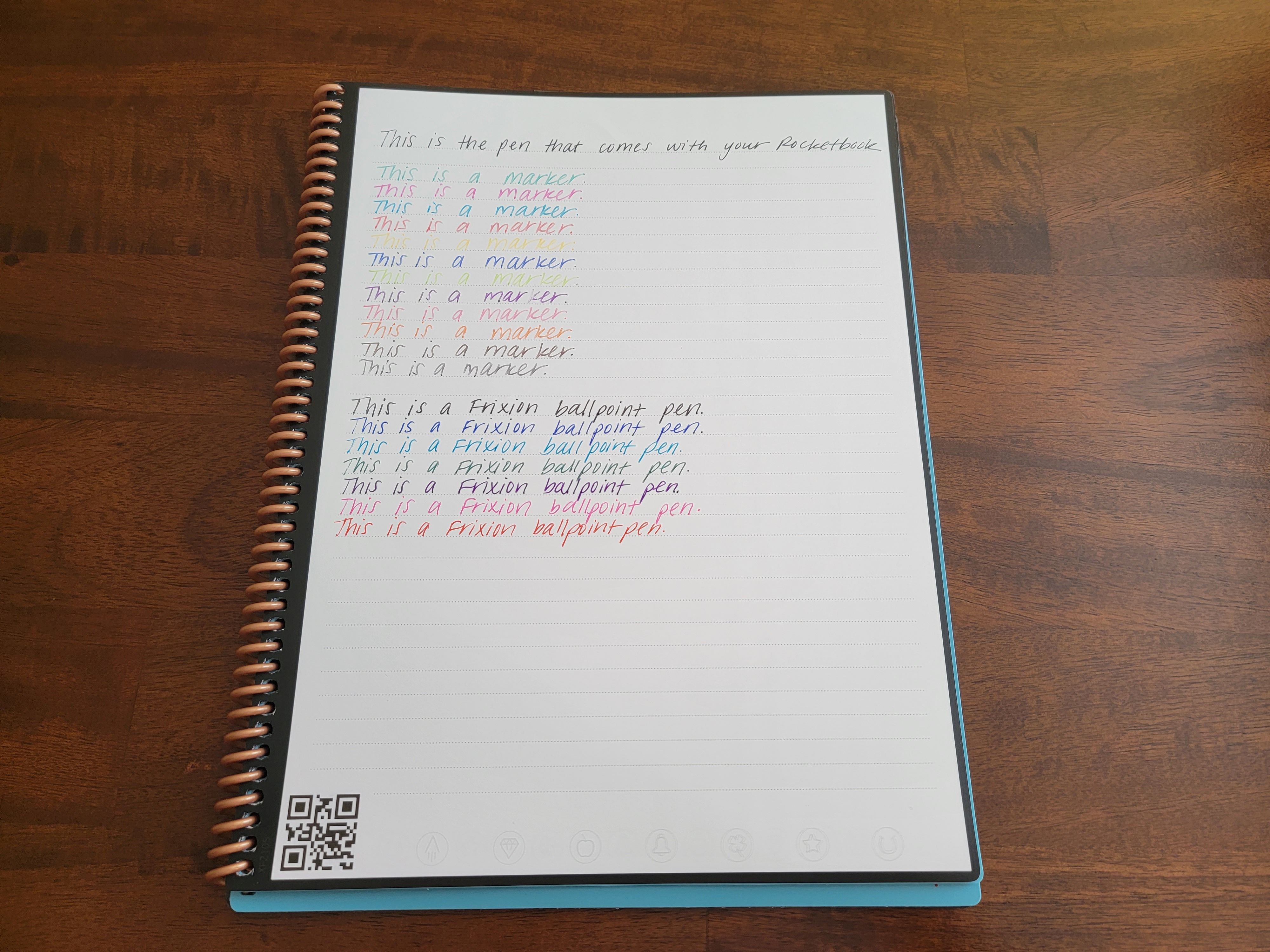 A rocketbook fusion smart notebook is showing what different pens and markers look like by writing the same sentence over and over again.