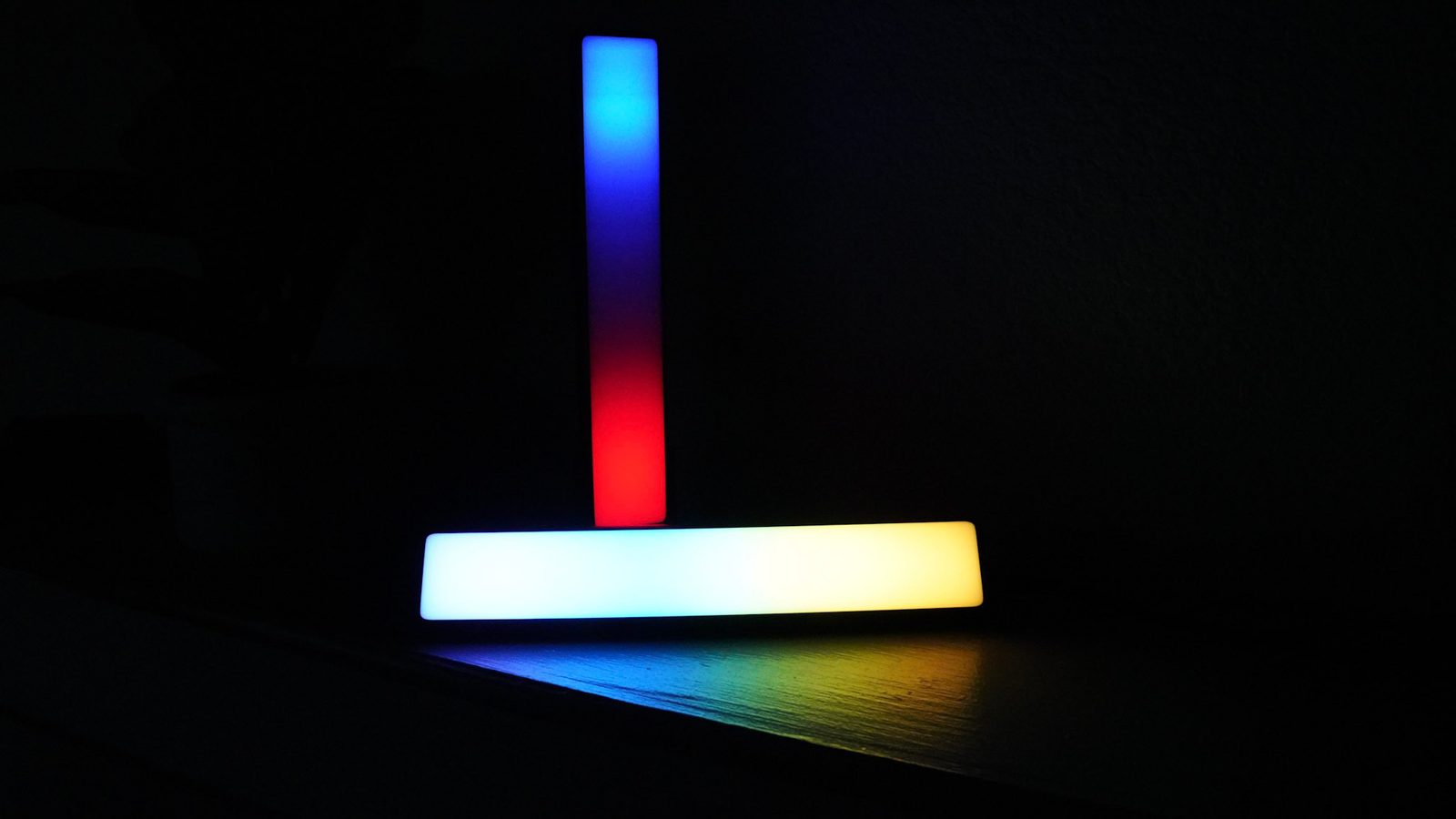 Govee Flow Plus light bars in dark room in segmented rainbow mode