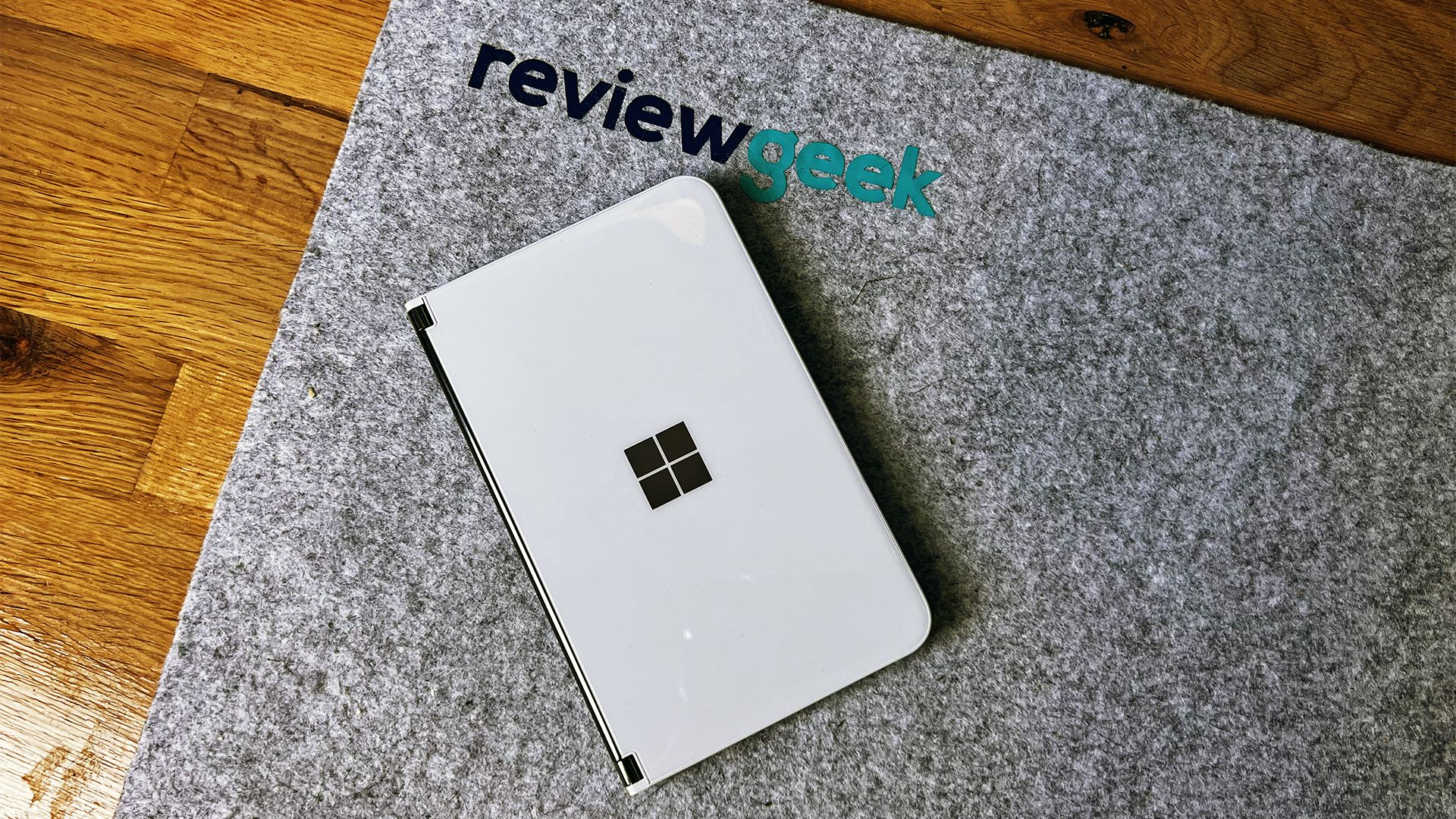 A closed Surface Duo 2 on a mat with the Review Geek Logo