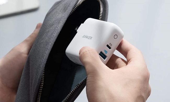 Person putting Anker charger into bag
